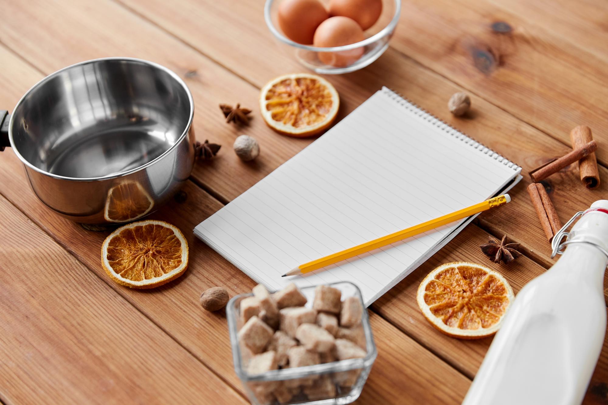 Workspace with cooking tools and an open notebook for recipes