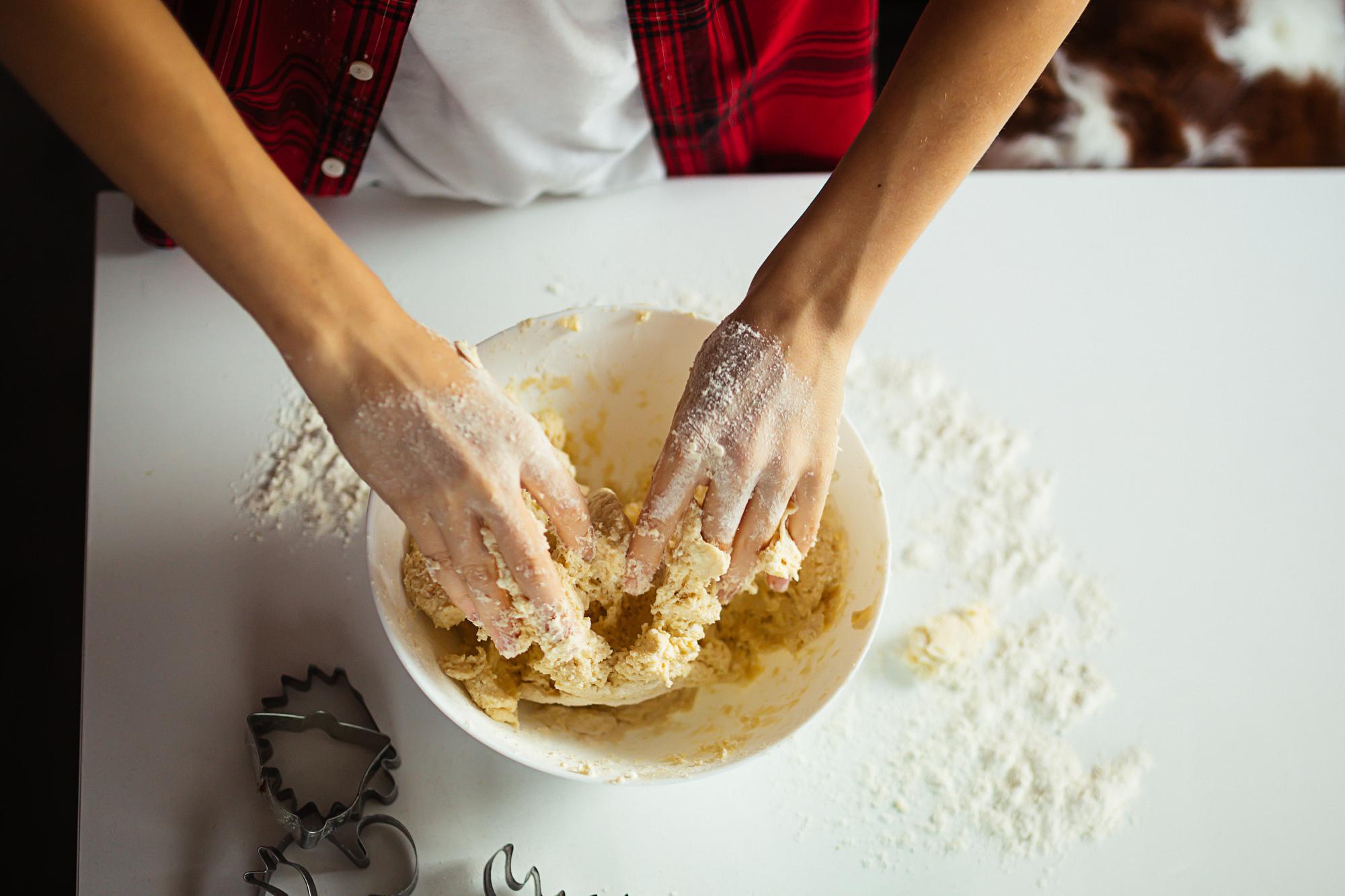 Close-up of hands kneading dough